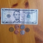 $5 Bill with various pennies types